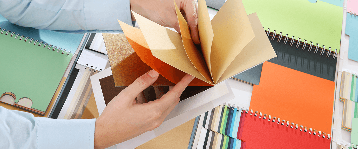 A person looking through paper samples