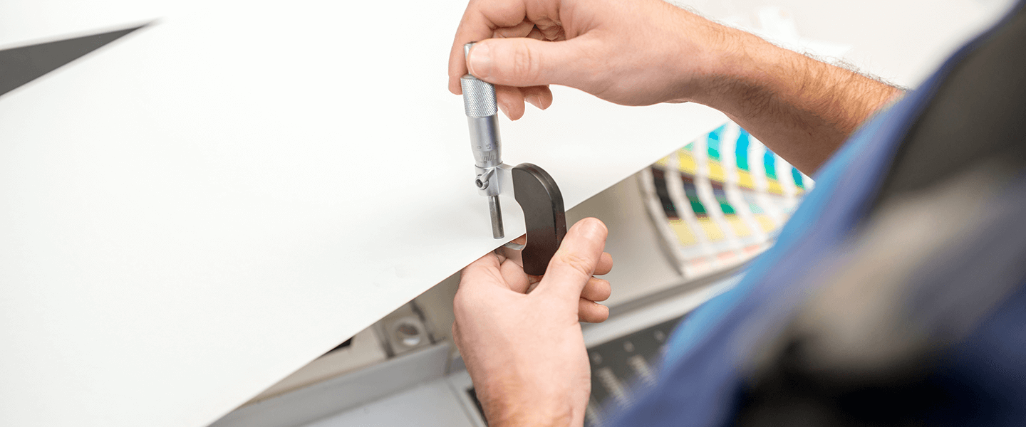 Someone hole punching a paper