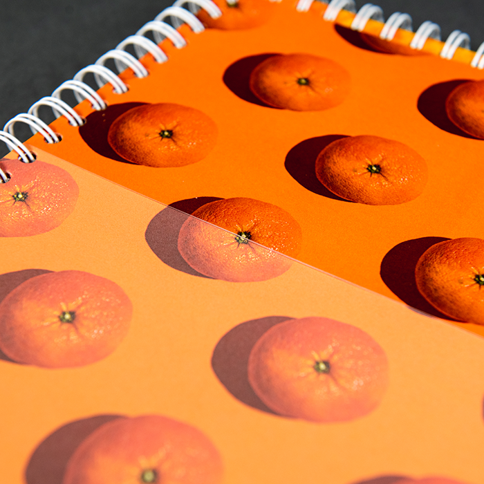 Spiral notebook with oranges on it